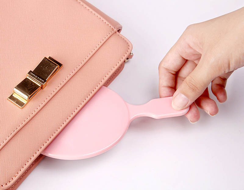 oval small pink handheld mirror